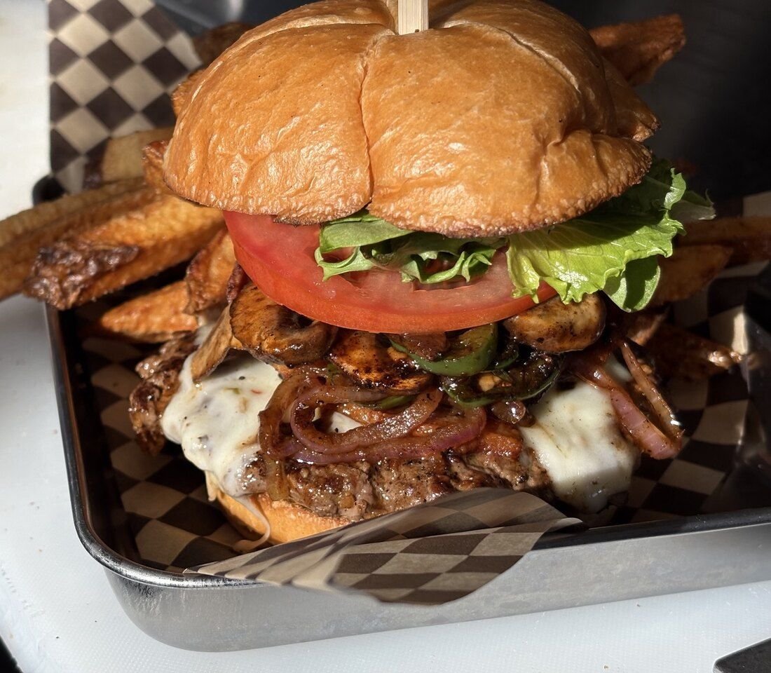 A photo of a stacked burger.